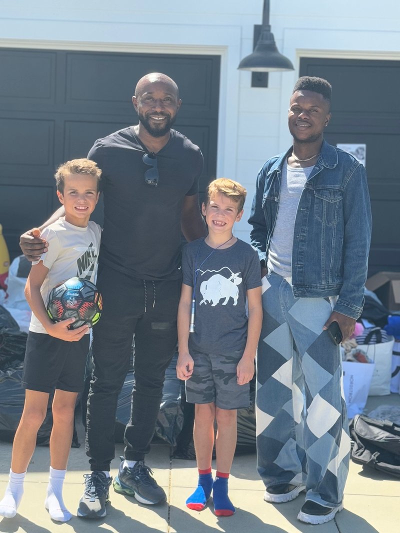 Team members posing with children at Rainbow Orphanage