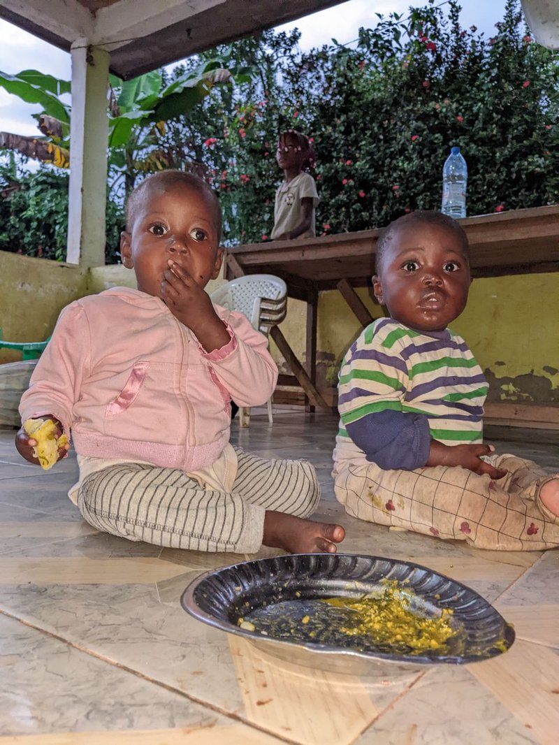 Young children sharing a meal at Rainbow Orphanage